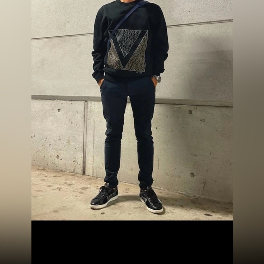 Louis Vuitton black crewneck sweatshirt with a geometric V graphic.